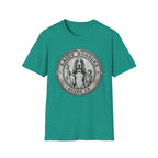 Saint Noodles Guide Us T-Shirt flat lay in teal, featuring a vintage medallion graphic of a basset hound standing upright holding a staff with a fish, alongside a small child, with the text 'Saint Noodles Guide Us'.