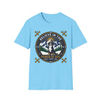 Believe in the Power of Dog Bernese T-Shirt in light blue, flat lay view showing a circular badge graphic with a halo-wearing Bernese Mountain Dog set against a mountain and forest landscape, with crossed bones and the words 'Loyalty Warmth Love'.