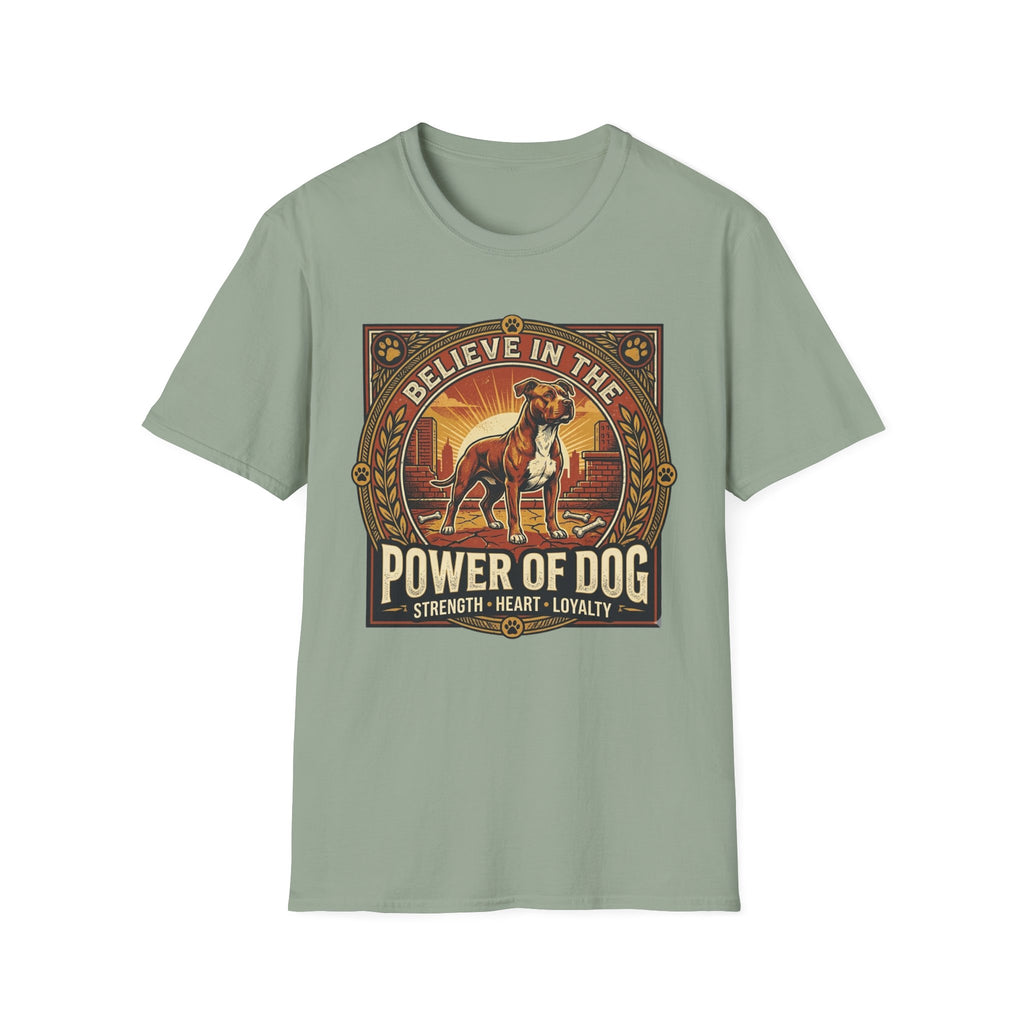 Believe in the Power of Dog Pitbull Cityscape T-Shirt in sage green, flat lay, featuring a retro-style badge graphic of a muscular brown and white Pitbull standing proudly before a warm urban cityscape at sunset, with text reading Believe in the Power of Dog and Strength, Heart, Loyalty.