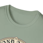 I Stand Amazed Belgian Malinois T-Shirt in sage green, close-up of the neckline and upper graphic detail showing the circular Belgian Malinois design with crossed-bone medallion and vintage lettering.