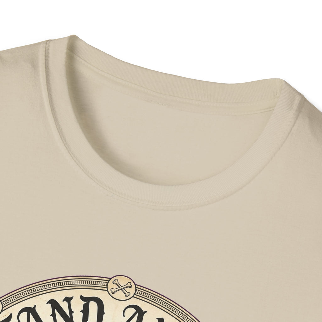 I Stand Amazed Pitbull T-Shirt in sand, close-up of the neckline and upper graphic detail showing the circular pitbull design with crossed-bone medallion and vintage lettering.