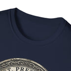 Saint Pretzel Forgive Us T-Shirt close-up detail shot on navy blue shirt showing the neckline and top portion of the St. Pretzel engraved medallion graphic.