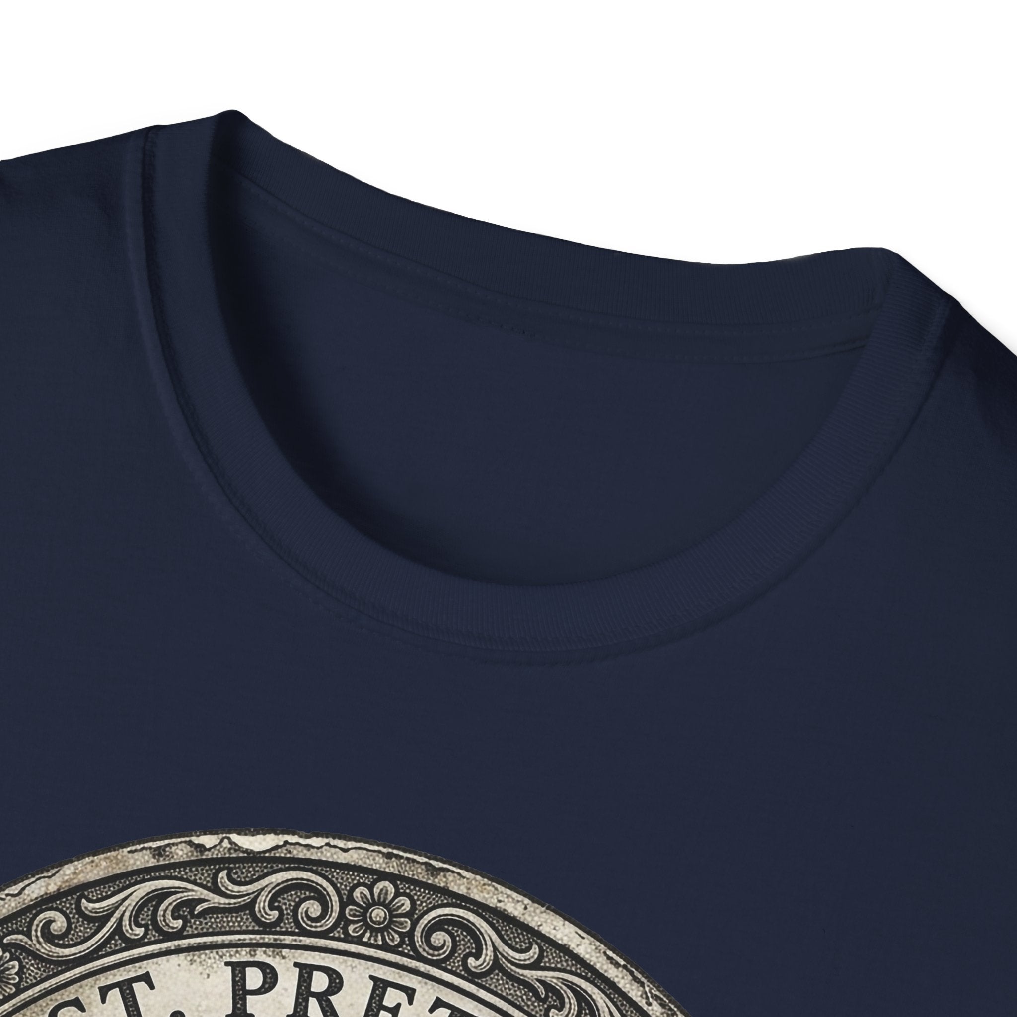 Saint Pretzel Forgive Us T-Shirt close-up detail shot on navy blue shirt showing the neckline and top portion of the St. Pretzel engraved medallion graphic.