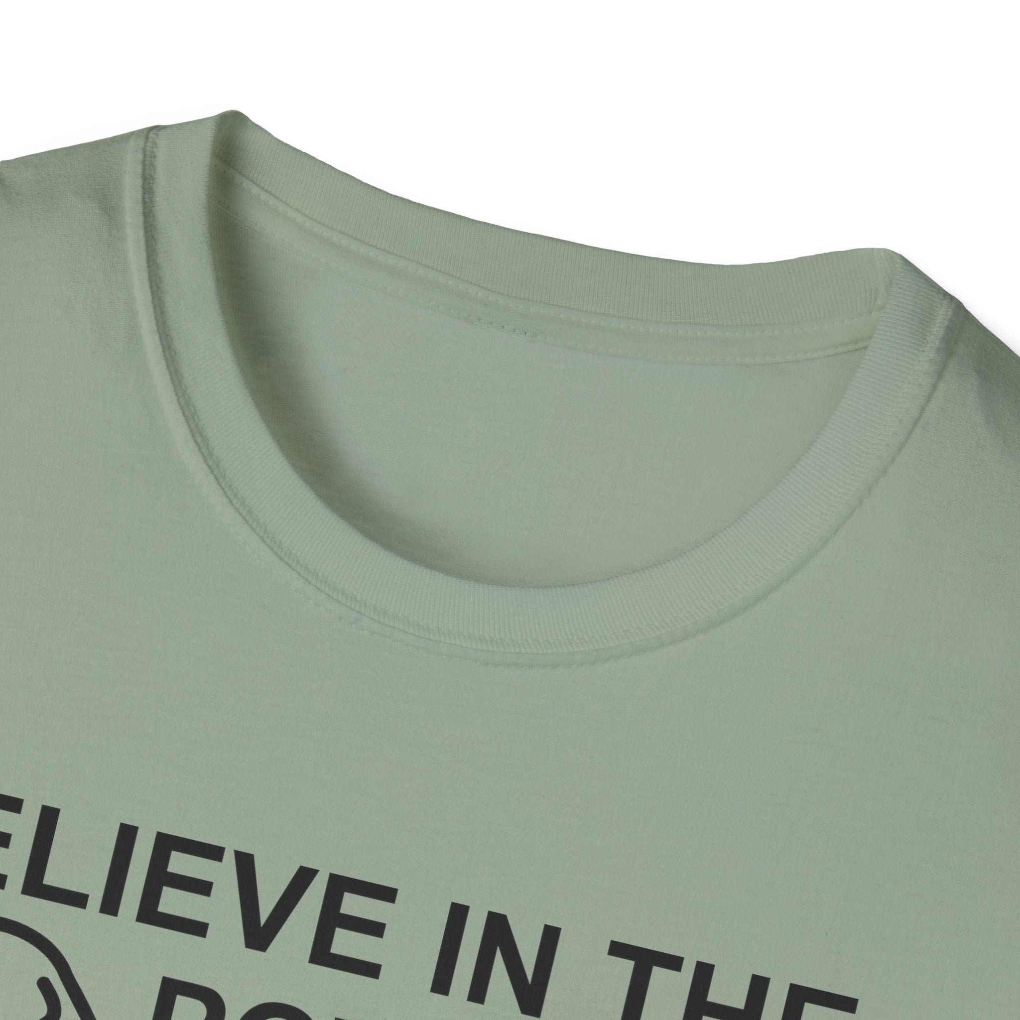 Believe in the Power of Dog T-Shirt close-up detail in sage green, showing the collar area and top of the graphic with dog outline and text Believe in the Power.