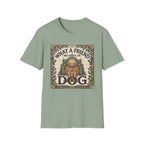 What a Friend We Have in Dog T-Shirt flat lay, sage green shirt featuring a vintage botanical-framed graphic of a golden retriever with a halo seated before a cathedral archway with the text 'What a Friend We Have in Dog.'