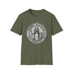 Saint Noodles Guide Us T-Shirt flat lay in military green, featuring a vintage medallion graphic of a basset hound standing upright holding a staff with a fish, alongside a small child, with the text 'Saint Noodles Guide Us'.