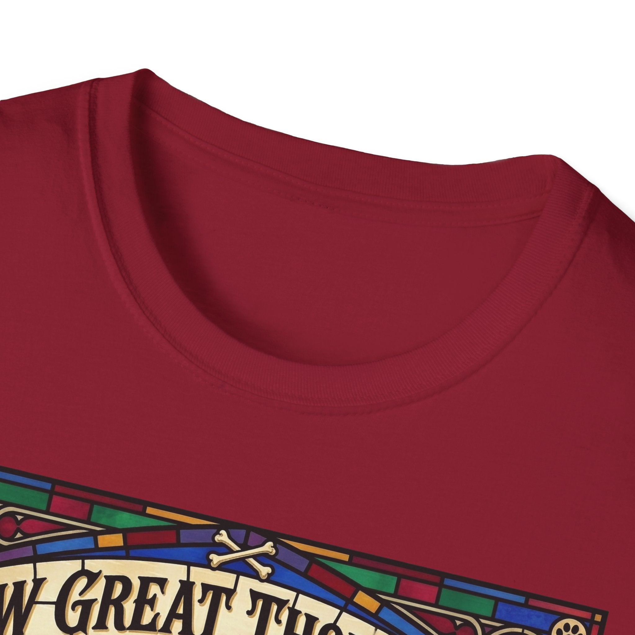 How Great Thou Bark Golden Retriever T-shirt close-up detail shot on a cardinal red shirt, showing the colorful stained-glass style graphic with crossbones and 'How Great Thou Bark' lettering at the neckline.