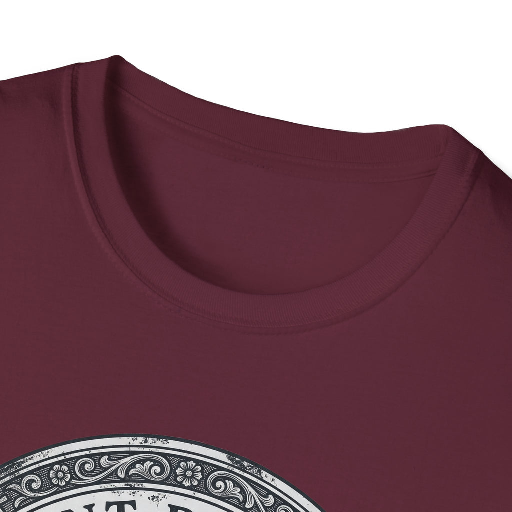 Saint Biscuit Heal Us T-shirt close-up detail on maroon shirt showing the ornate circular border and 'Saint Biscuit' text of the vintage medallion graphic.