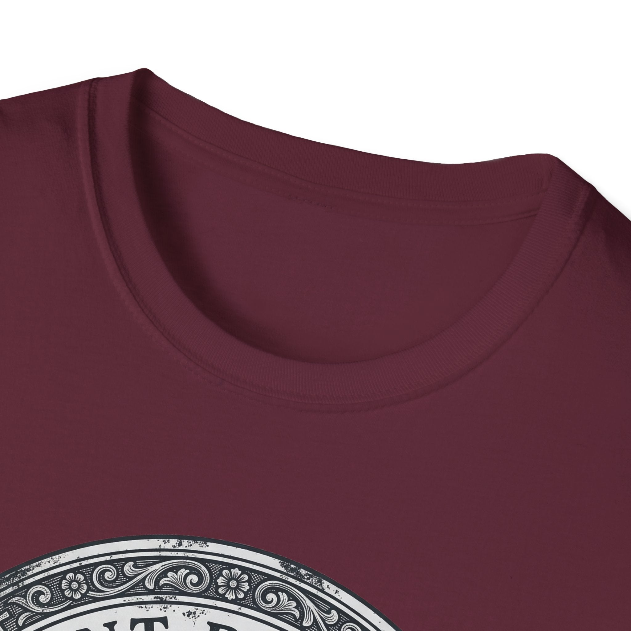 Saint Biscuit Heal Us T-shirt close-up detail on maroon shirt showing the ornate circular border and 'Saint Biscuit' text of the vintage medallion graphic.