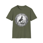 Saint Meatball Defend Us T-Shirt flat lay on military green shirt featuring a vintage medallion design with a Doberman Pinscher saint standing guard, reading Saint Meatball Defend Us.