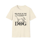 Believe in the Power of Dog T-Shirt flat lay in natural cream, featuring a line-art dog silhouette above bold DOG lettering with a paw print in the O.