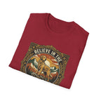 Believe in the Power of Dog T-shirt folded flat lay in cardinal red, showing the ornate vintage badge graphic of a Labrador on a rocky mountain outcrop with 'Believe in the' arched text at top.