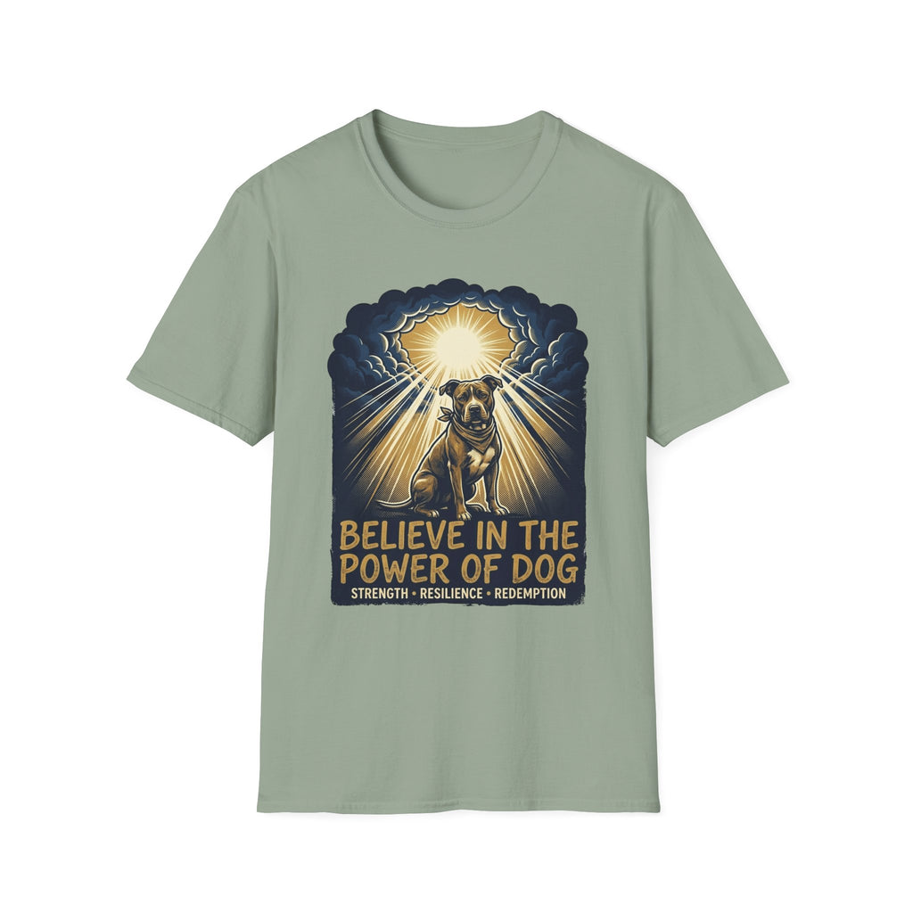 Believe in the Power Pitbull Clouds T-Shirt in sage green, flat lay, featuring a dramatic illustrated graphic of a brindle Pitbull standing before a burst of heavenly light breaking through storm clouds, with text reading Believe in the Power of Dog and Strength, Resilience, Redemption.