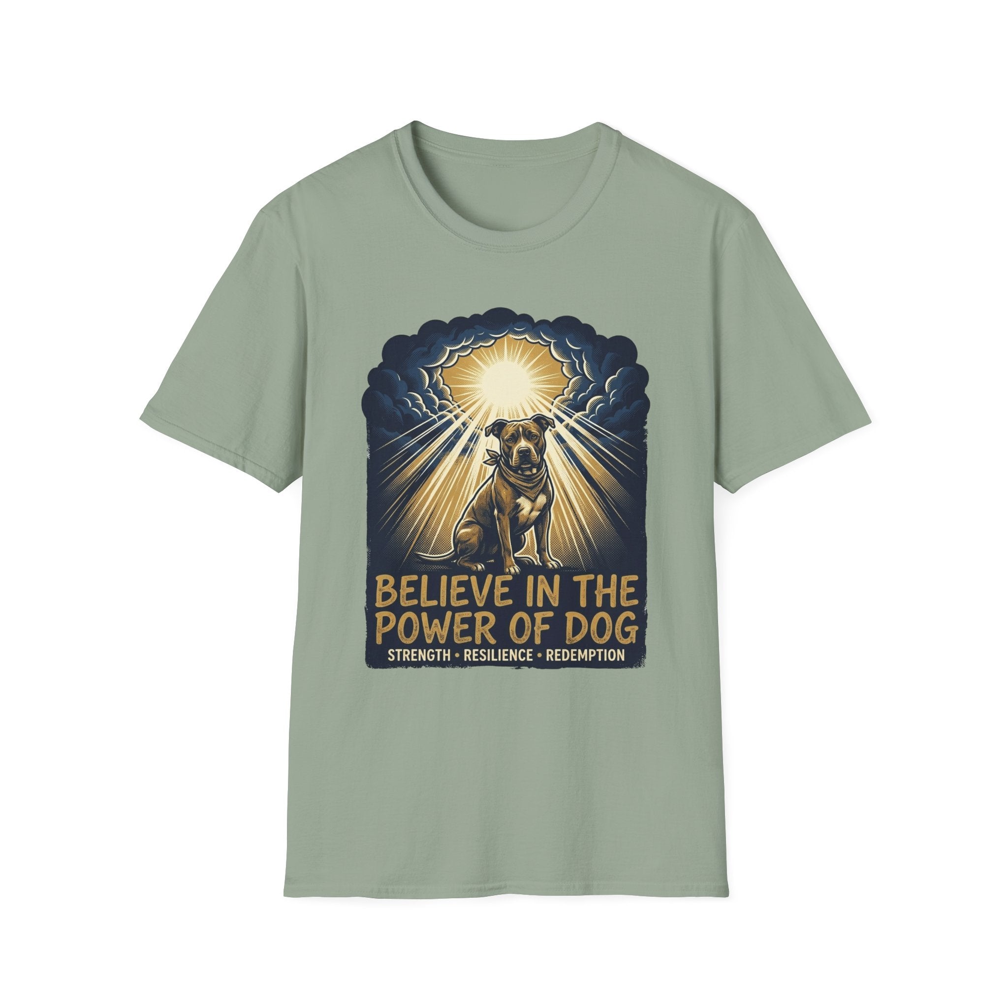 Believe in the Power Pitbull Clouds T-Shirt in sage green, flat lay, featuring a dramatic illustrated graphic of a brindle Pitbull standing before a burst of heavenly light breaking through storm clouds, with text reading Believe in the Power of Dog and Strength, Resilience, Redemption.