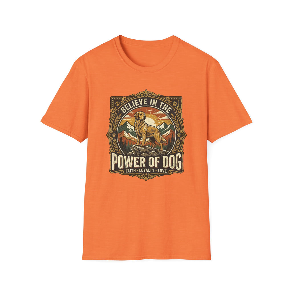 Believe in the Power of Dog T-shirt flat lay in orange, featuring a vintage ornate badge graphic of a Labrador standing on a rocky mountain outcrop at sunset, with the text 'Believe in the Power of Dog' and 'Faith, Loyalty, Love'.