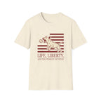 Pursuit of Fetch T-Shirt flat lay in natural cream, featuring a leaping dog catching a tennis ball over a flag of red stripes and stars, with text reading 'Life, Liberty, and the Pursuit of Fetch.'