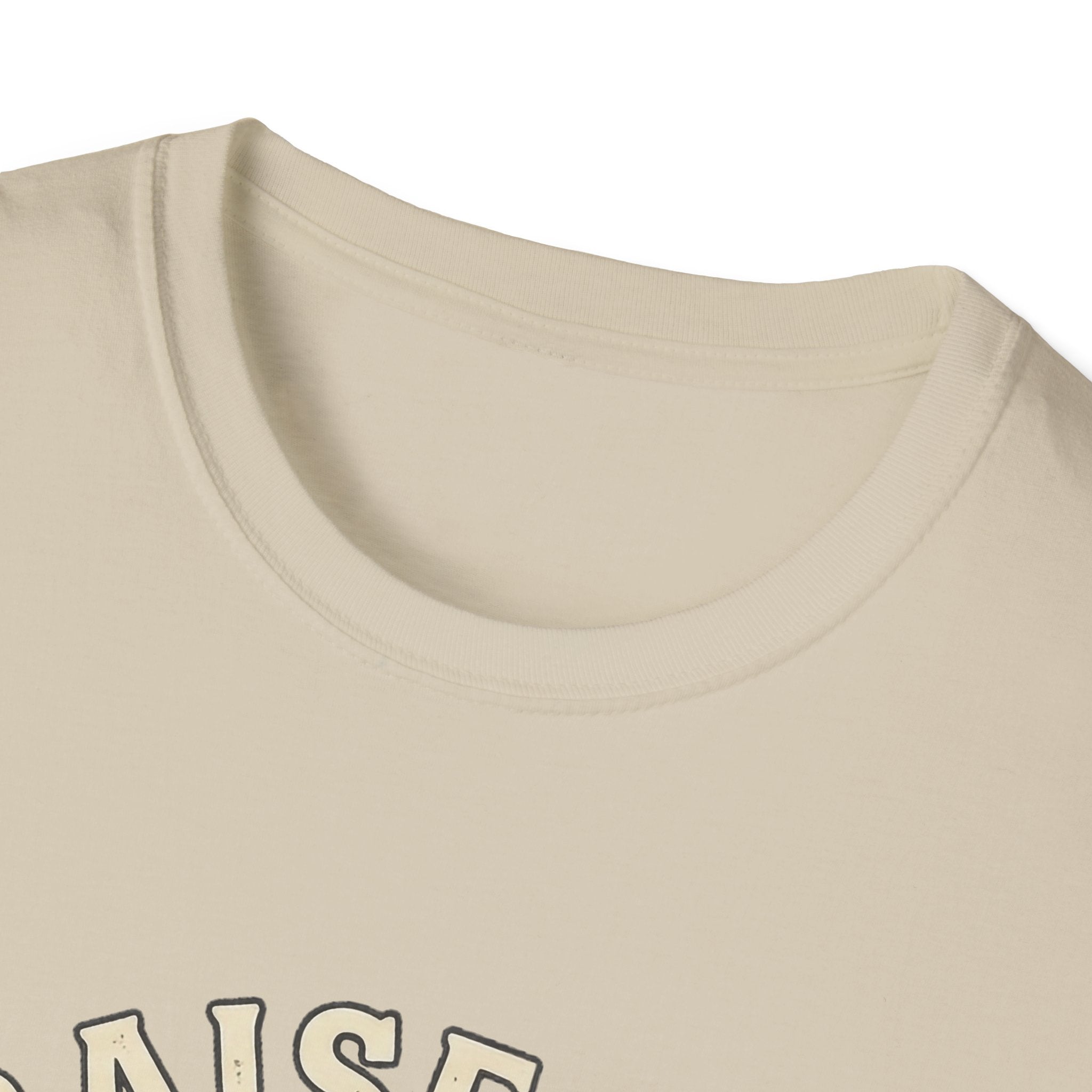 Praise Dog From Whom All Blessings Flow Labrador T-Shirt close-up detail of the collar area on a natural tan shirt, showing the top of the Praise Dog text graphic.
