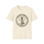I Stand Amazed Belgian Malinois T-Shirt in natural, flat lay front view featuring a vintage-style circular graphic of a Belgian Malinois with a halo, with the text 'I Stand Amazed in the Presence of Dog.'
