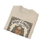 What a Friend We Have in Dog T-Shirt folded view, natural tan shirt showing the full graphic of a golden retriever with halo framed by oak leaves, thistles, and paw prints with the text 'What a Friend We Have in Dog.'