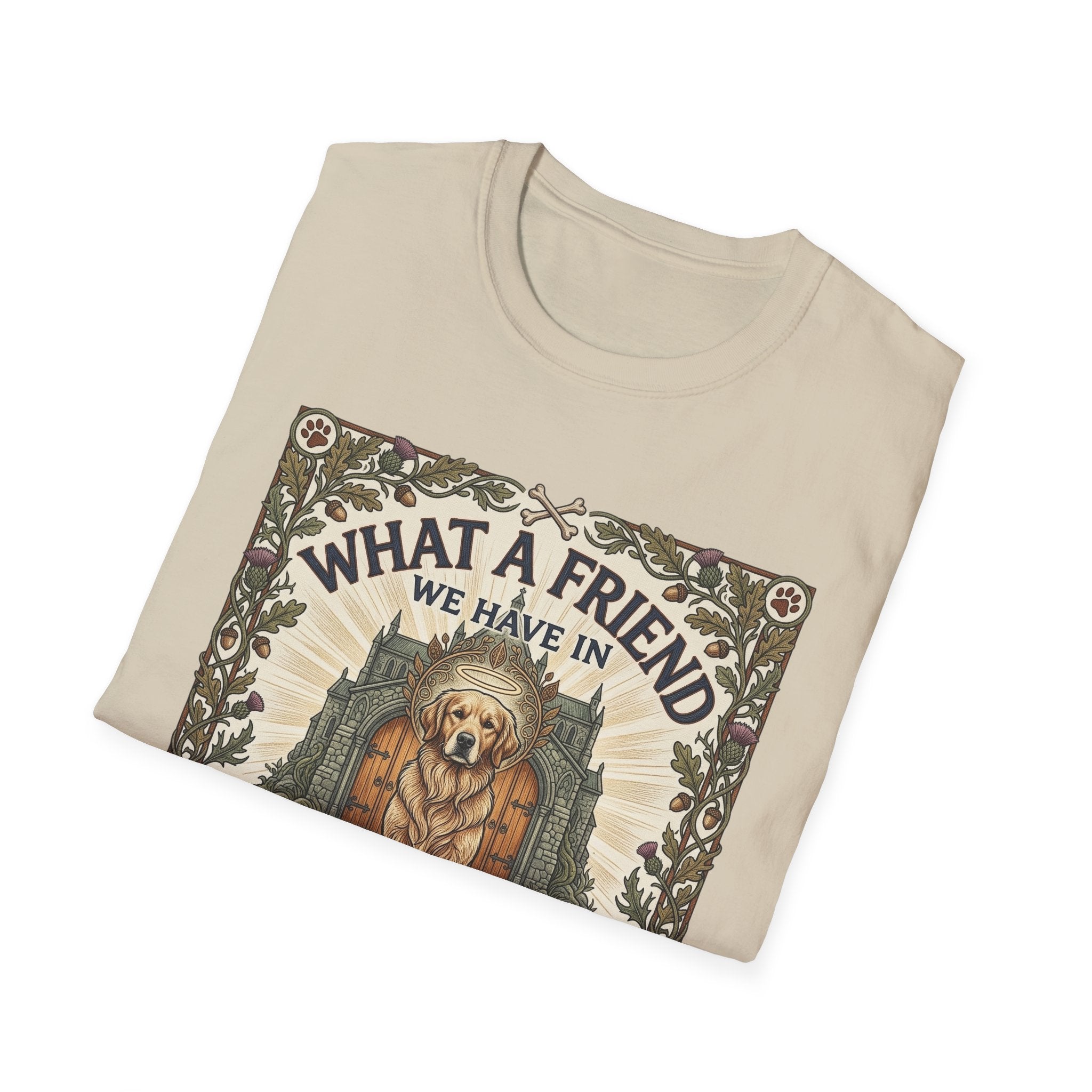 What a Friend We Have in Dog T-Shirt folded view, natural tan shirt showing the full graphic of a golden retriever with halo framed by oak leaves, thistles, and paw prints with the text 'What a Friend We Have in Dog.'