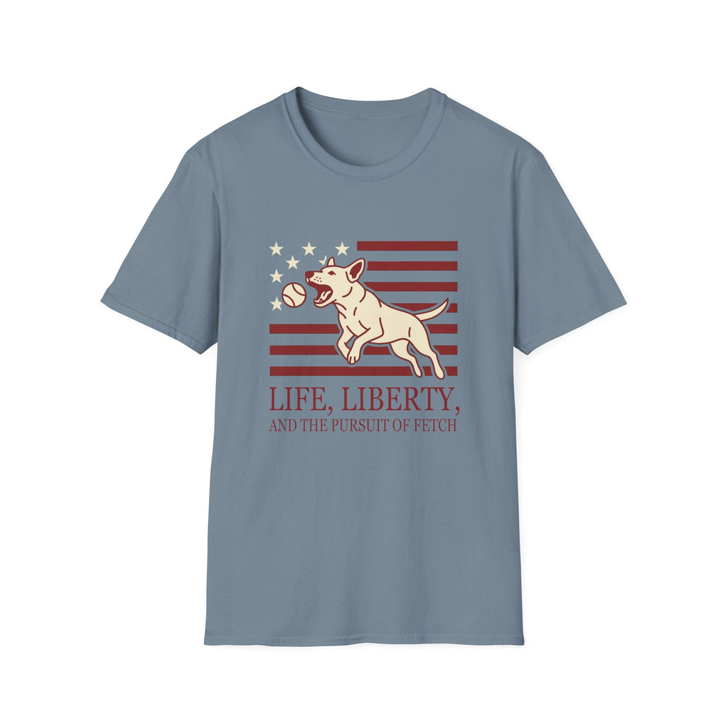 Pursuit of Fetch T-Shirt flat lay in slate blue, featuring a leaping dog catching a tennis ball over a flag of red stripes and stars, with text reading 'Life, Liberty, and the Pursuit of Fetch.'
