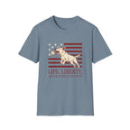 Pursuit of Fetch T-Shirt flat lay in slate blue, featuring a leaping dog catching a tennis ball over a flag of red stripes and stars, with text reading 'Life, Liberty, and the Pursuit of Fetch.'