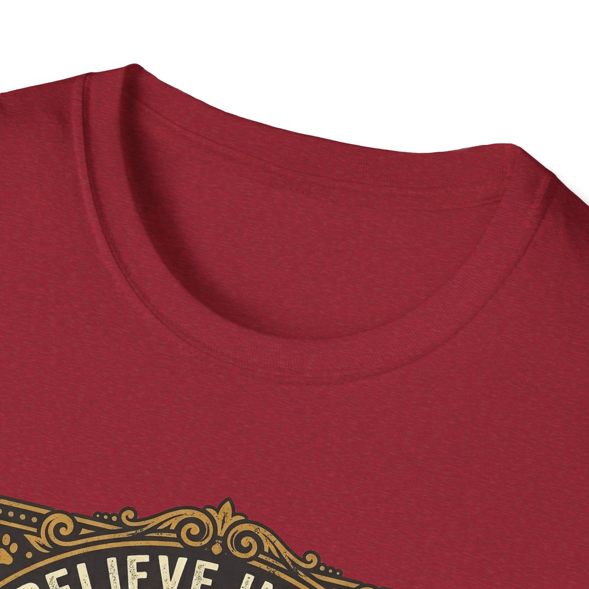 Believe in the Power of Dog T-shirt close-up detail on cardinal red shirt showing the ornate gold border and 'Believe In The' text of the vintage badge graphic.