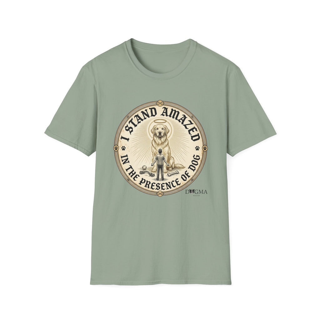 I Stand Amazed Golden Retriever T-Shirt flat lay in sage green, featuring a circular vintage-style graphic of a golden retriever with a halo and rays of light, a small human figure standing beside the dog, with text "I Stand Amazed in the Presence of Dog" and Dogma House branding.