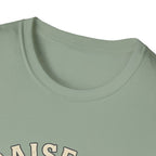 Praise Dog From Whom All Blessings Flow Labrador T-Shirt close-up detail of the collar area on a sage green shirt, showing the top of the Praise Dog text graphic.
