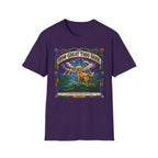 How Great Thou Bark Golden Retriever T-shirt flat lay, purple shirt featuring a stained-glass style graphic of a golden retriever on a hilltop with sunbeams and the text 'How Great Thou Bark – A Hymn for the Devoted.'