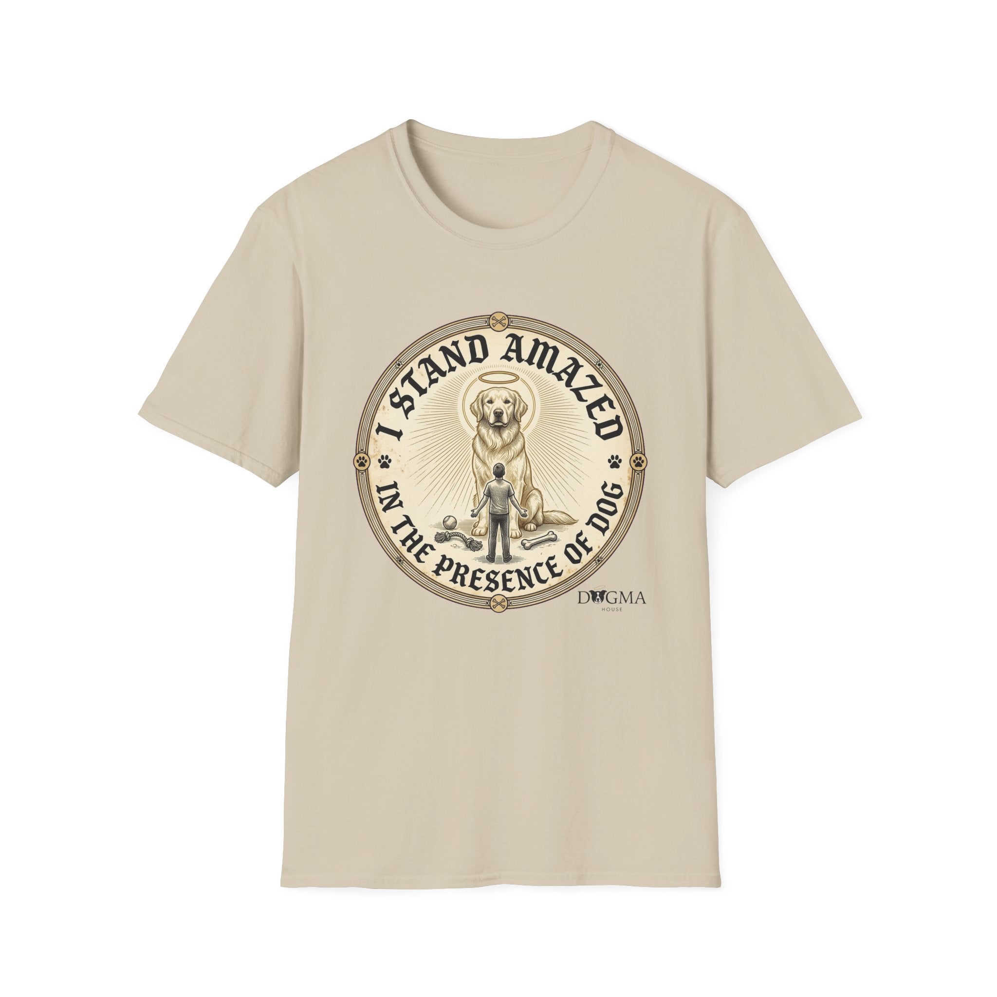 I Stand Amazed Golden Retriever T-Shirt flat lay in sand, featuring a circular vintage-style graphic of a golden retriever with a halo and the text "I Stand Amazed in the Presence of Dog" with Dogma House branding.