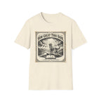 How Great Thou Bark Monotone T-Shirt flat lay on natural/cream shirt featuring a vintage-style sepia graphic of a dog standing on a hilltop with divine rays of light and an open bible, with the text 'How Great Thou Bark – A Hymn for the Devoted.'