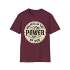 Believe in the Power of Dog Paw T-shirt flat lay in maroon, featuring a circular vintage badge graphic of a dog paw raised like a fist from clouds above crossed bones, with paw print accents and bold text.