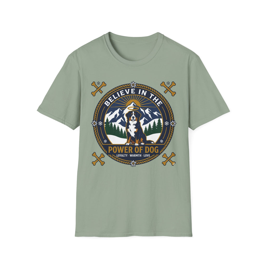 Believe in the Power of Dog Bernese T-Shirt in sage green, flat lay view showing a circular badge graphic with a halo-wearing Bernese Mountain Dog set against a mountain and forest landscape, with crossed bones and the words 'Loyalty Warmth Love'.