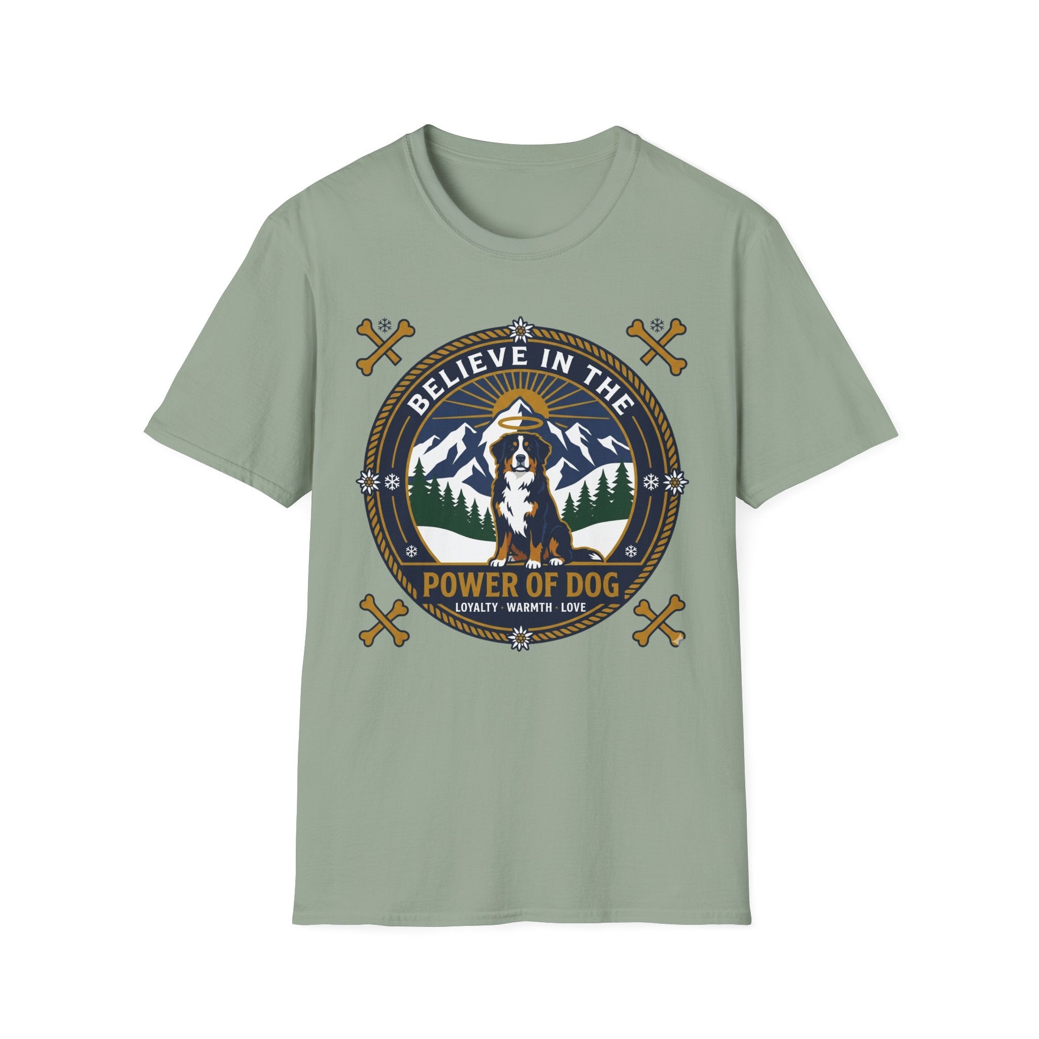 Believe in the Power of Dog Bernese T-Shirt in sage green, flat lay view showing a circular badge graphic with a halo-wearing Bernese Mountain Dog set against a mountain and forest landscape, with crossed bones and the words 'Loyalty Warmth Love'.