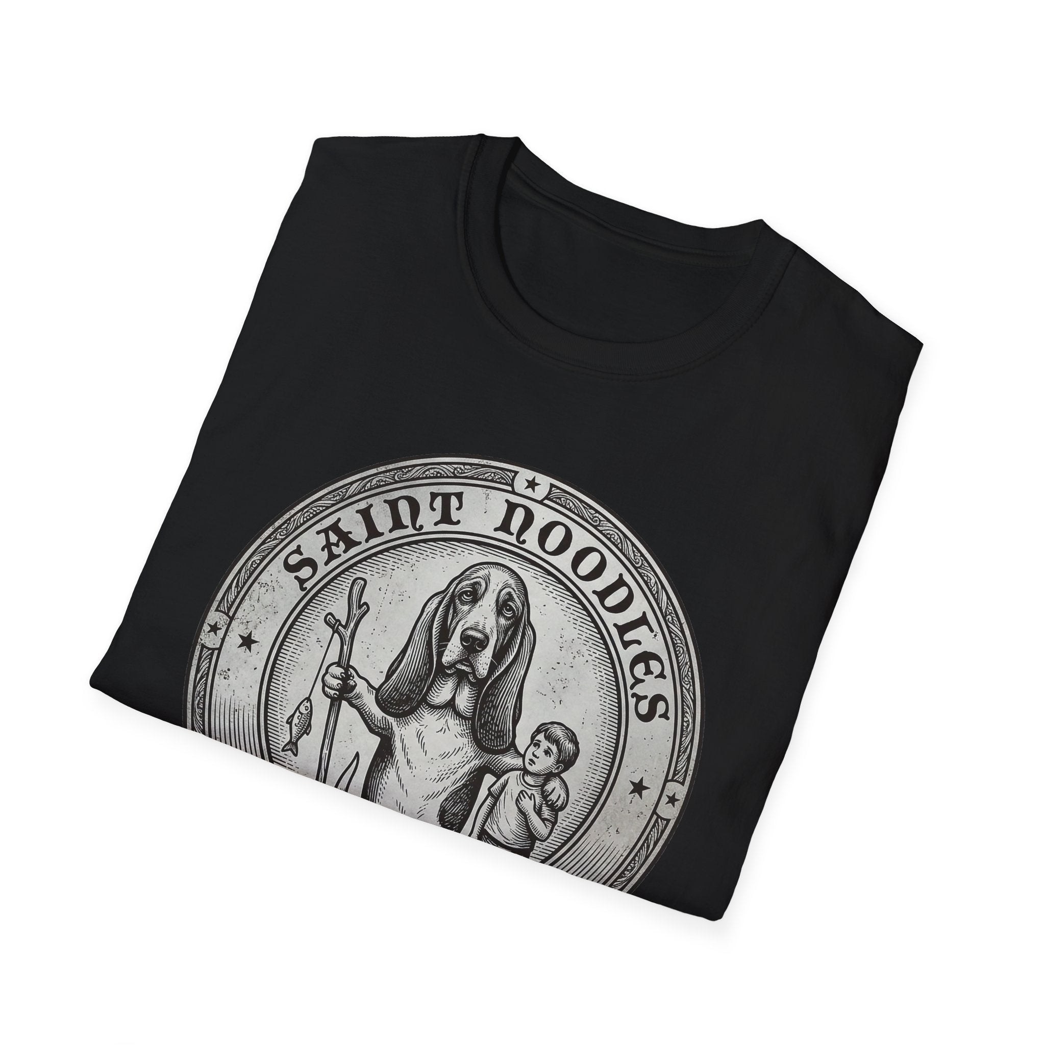Saint Noodles Guide Us T-Shirt folded flat lay in black, showing the 'Saint Noodles' medallion graphic with a basset hound holding a staff with a fish.