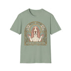 Let Go Let Dog Basset Hound T-Shirt in sage green, flat lay, featuring an Art Nouveau-style oval frame with floral motifs and a serene basset hound raising both paws with the text 'Let Go and Let Dog'.