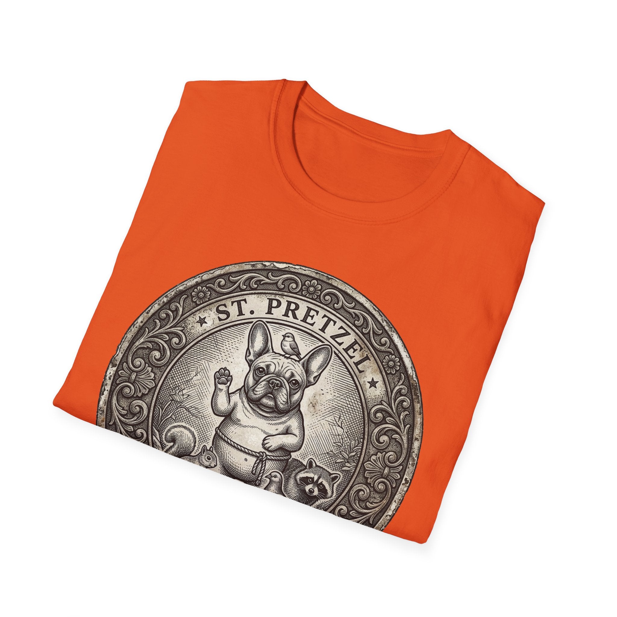 Saint Pretzel Forgive Us T-Shirt folded flat lay on orange shirt showing the St. Pretzel French Bulldog medallion design.