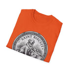 Saint Biscuit Heal Us T-shirt folded flat lay in orange, showing the 'Saint Biscuit' medallion graphic with a golden retriever comforting a reclining figure.