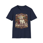 Believe in the Power of Dog Shih Tzu Throne T-Shirt in navy blue, flat lay, featuring a vintage badge graphic of a fluffy white Shih Tzu seated regally on a throne surrounded by lotus flowers and mountains, with text reading Believe in the Power of Dog and Grace, Wisdom, Devotion.