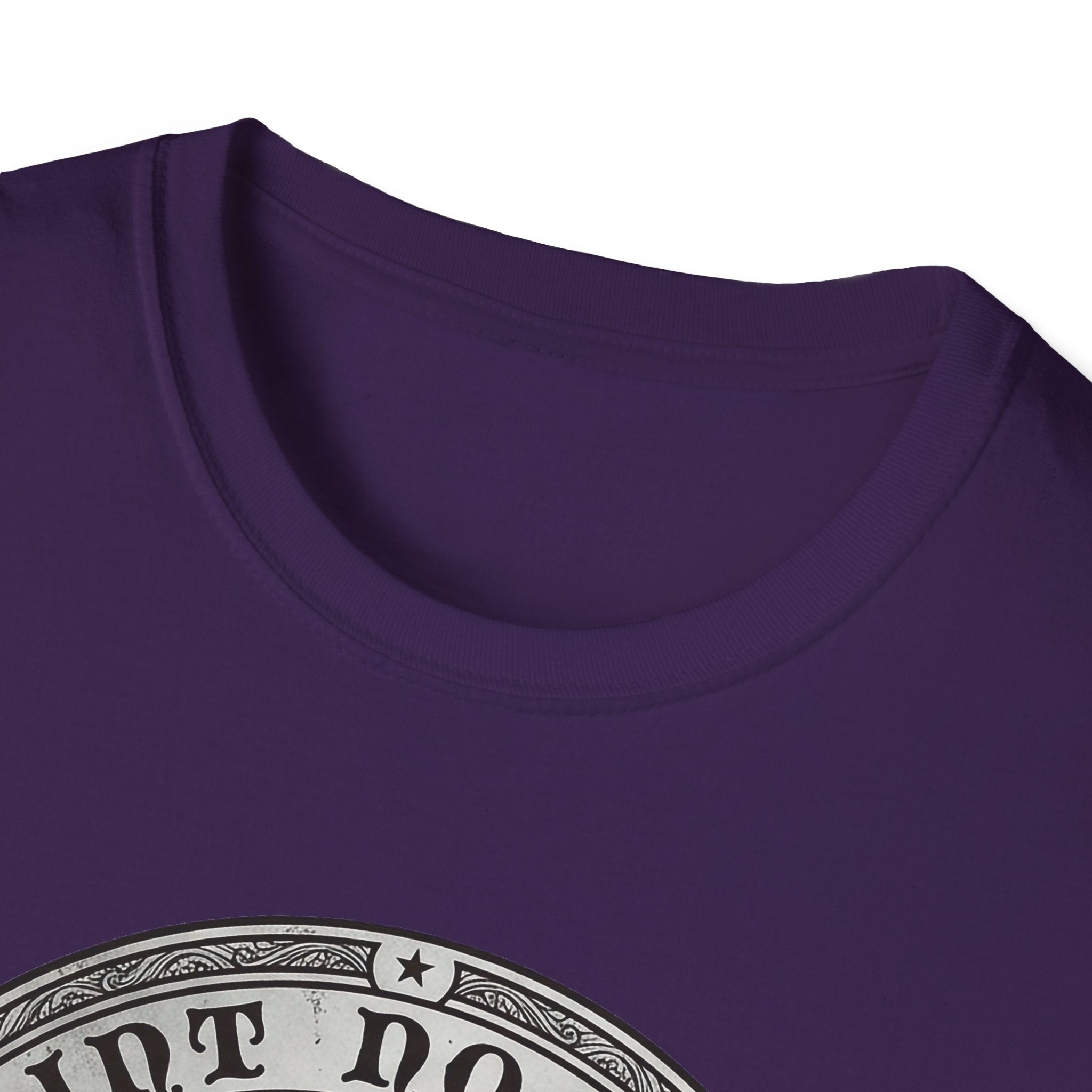 Saint Noodles Guide Us T-Shirt close-up detail on purple shirt showing the circular border and top portion of the basset hound Saint Noodles medallion graphic.