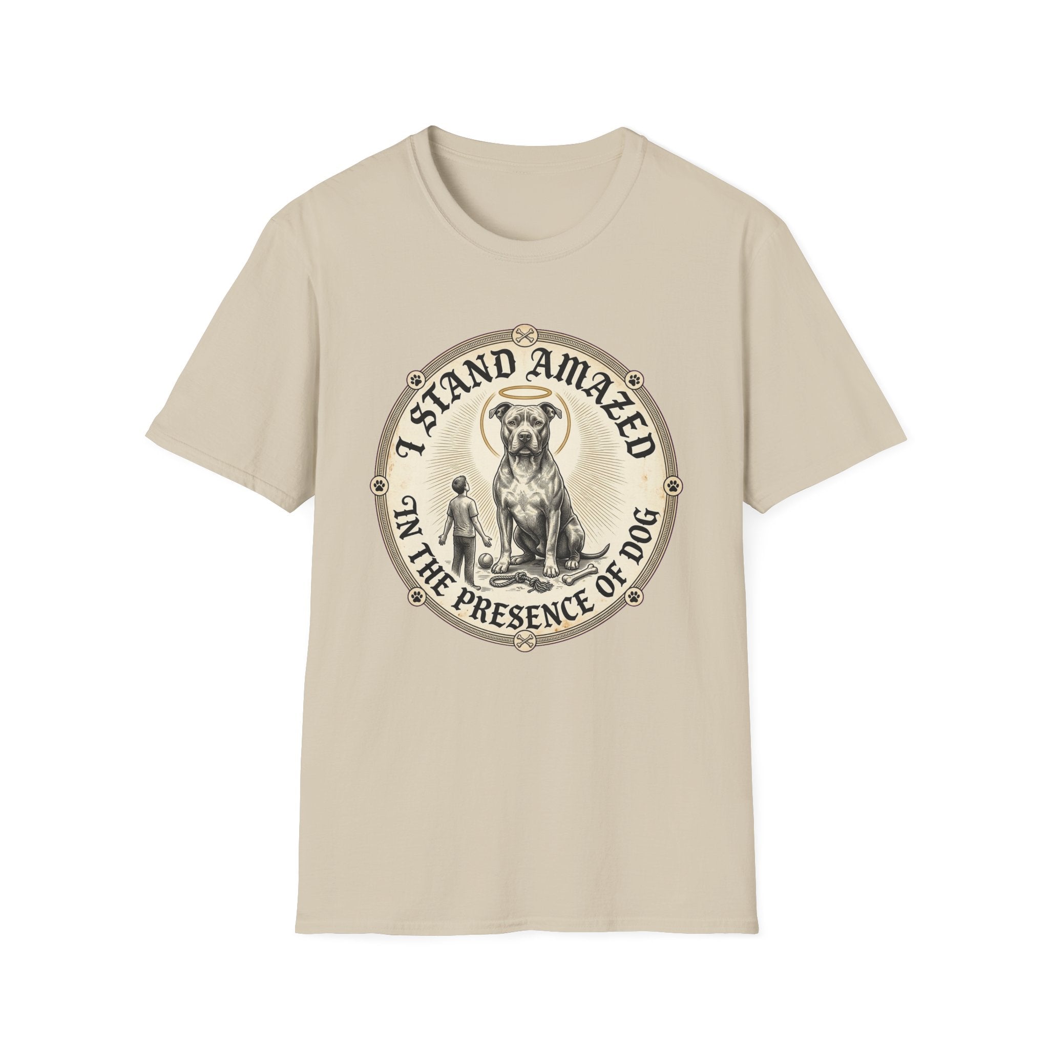 I Stand Amazed Pitbull T-Shirt in sand, flat lay front view showing a vintage-style circular graphic of a pitbull with a halo seated above a small human figure, with the text 'I Stand Amazed in the Presence of Dog.'