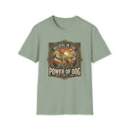 Believe in the Power of Dog T-shirt flat lay in sage green, featuring a vintage ornate badge graphic of a Labrador standing on a rocky mountain outcrop at sunset, with the text 'Believe in the Power of Dog' and 'Faith, Loyalty, Love'.
