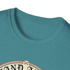 I Stand Amazed Belgian Malinois T-Shirt in heather teal, close-up of the neckline and upper graphic detail showing the circular Belgian Malinois design with crossed-bone medallion and vintage lettering.
