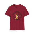 The Joyful Sound of Barking T-shirt flat lay, cardinal red shirt featuring a circular badge graphic of a cartoon yellow dog with a red bandana howling joyfully with musical notes and the text 'The Joyful Sound of Barking.'