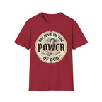 Believe in the Power of Dog Paw T-shirt flat lay in cardinal red, featuring a circular vintage badge graphic of a dog paw raised like a fist from clouds above crossed bones, with paw print accents and bold text.