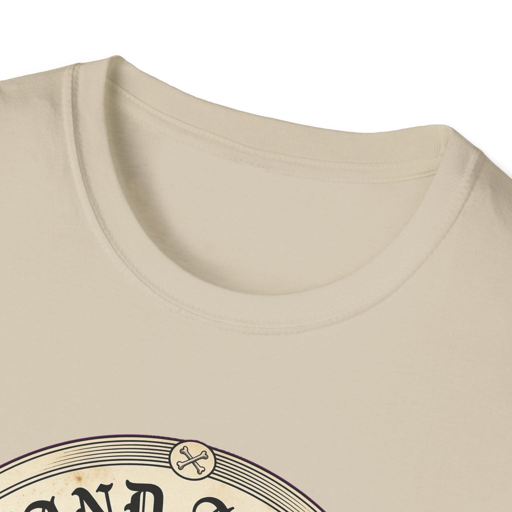 I Stand Amazed Rescue Mutt T-Shirt in sand, close-up of the neckline and upper graphic detail showing the circular rescue mutt design with crossed-bone medallion and vintage lettering.