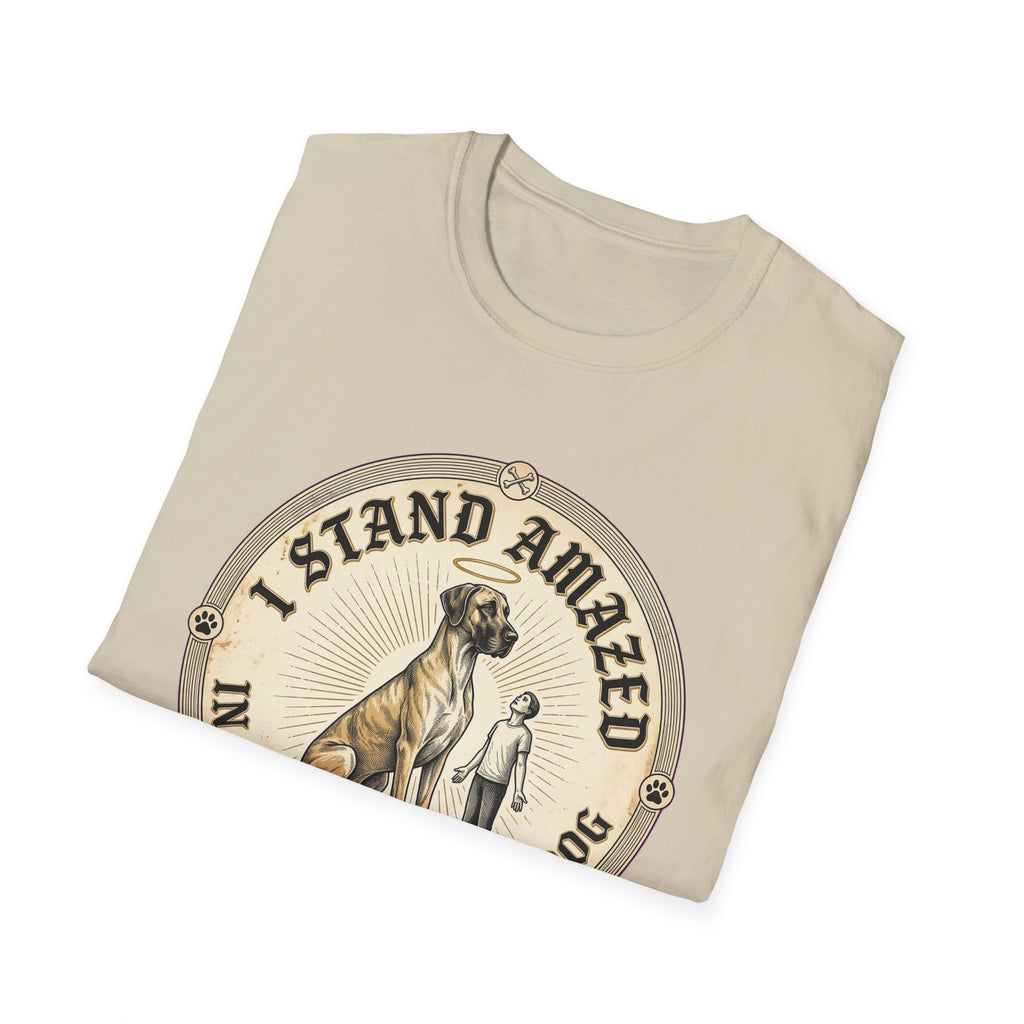 I Stand Amazed Great Dane T-Shirt folded view in sand, showing the massive Great Dane with halo graphic and "I Stand Amazed" text on the front.
