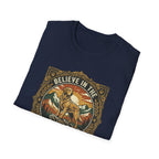 Believe in the Power of Dog T-shirt folded flat lay in navy blue, showing the ornate vintage badge graphic of a Labrador on a rocky mountain outcrop with 'Believe in the' arched text at top.