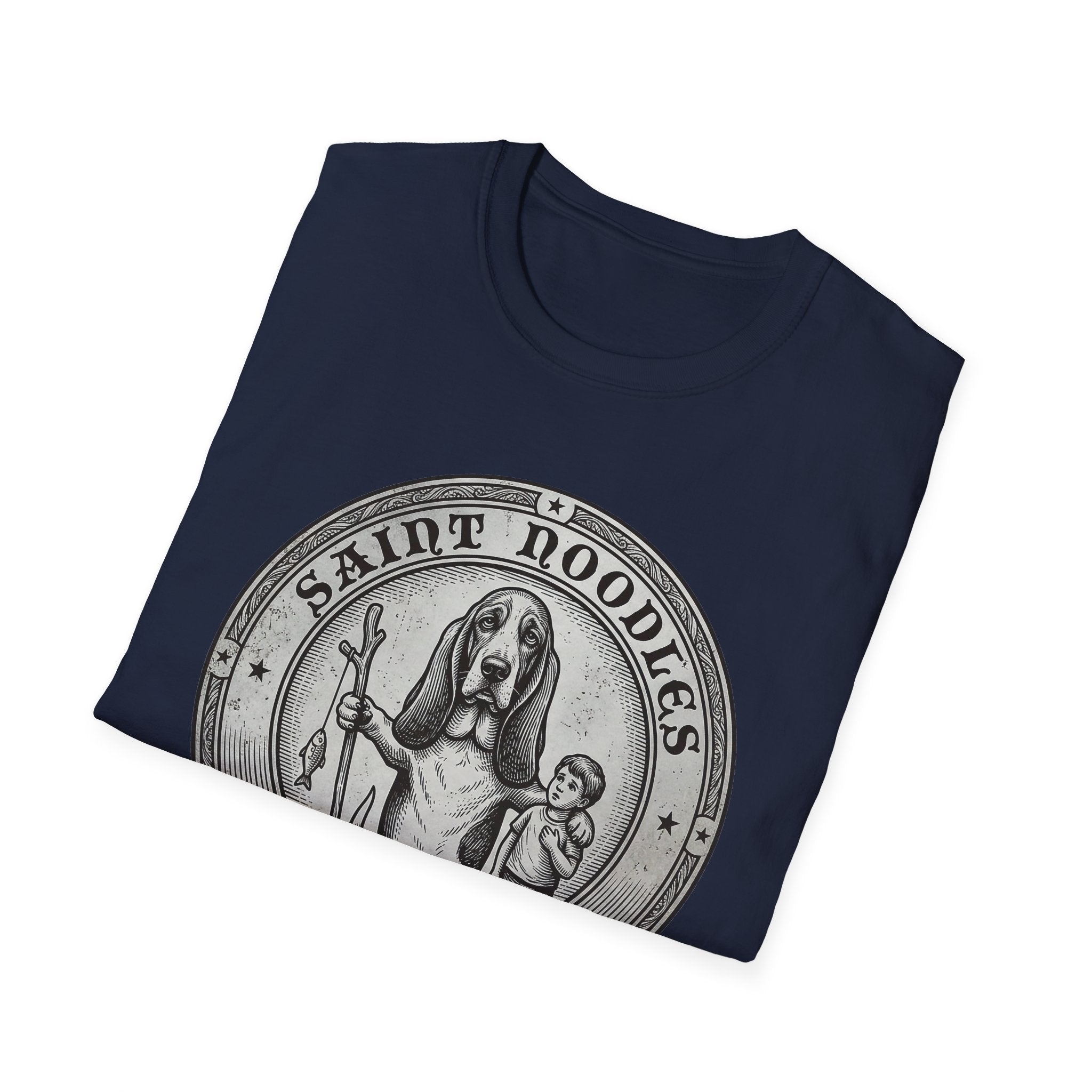 Saint Noodles Guide Us T-Shirt folded flat lay in navy blue, showing the 'Saint Noodles' medallion graphic with a basset hound holding a staff with a fish.